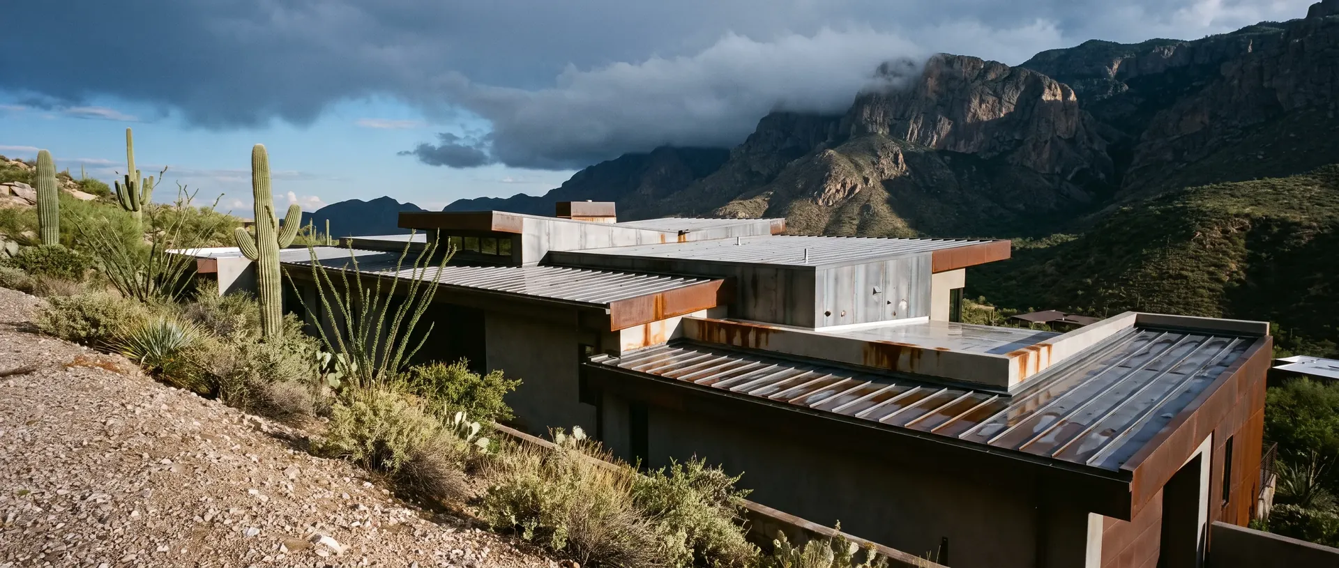 Desert modern Catalina Foothills house with multiple metal roof planes on a steep lot
