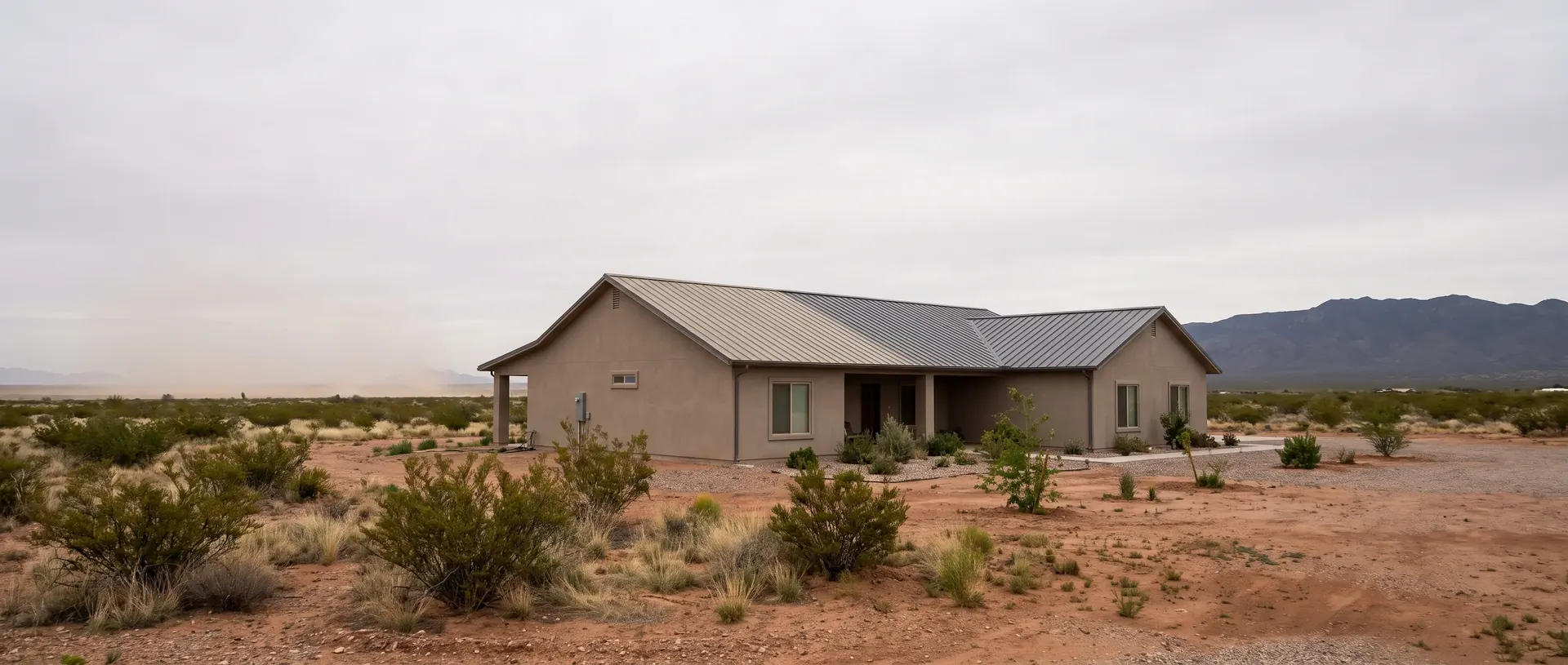 Marana house with a metal roof slope dulled by blowing dust off the I-10 corridor